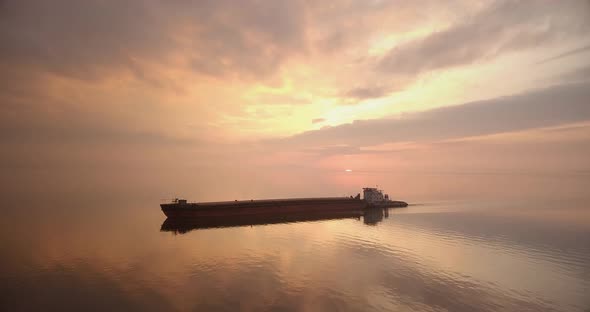 Large Cargo Ship Sailing During A Beautiful Sunset