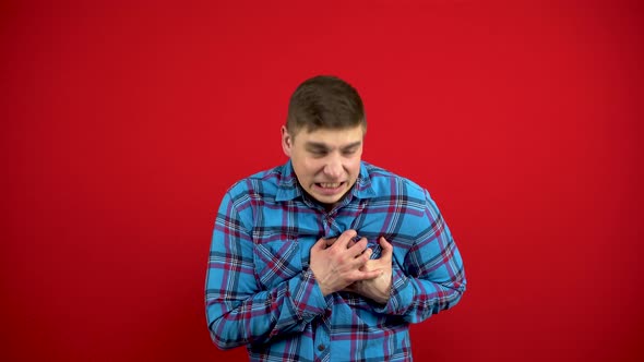 A Young Man Has a Heartache She Holds It with Her Hand alt