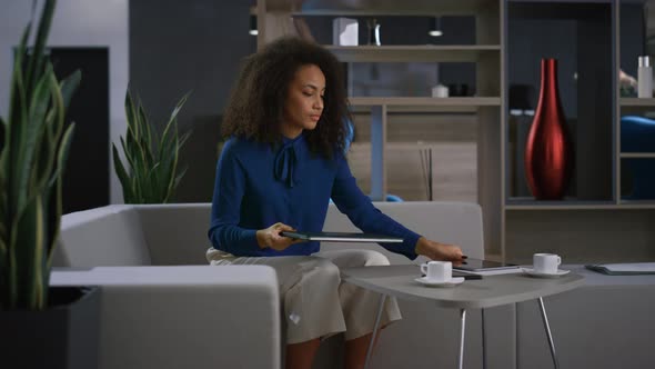 Tired African American Businesswoman Leaving Office Closing Laptop in Workplace alt