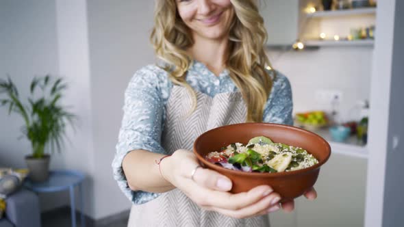 Woman Shows to Camera Bowl with Healthy Breakfast
