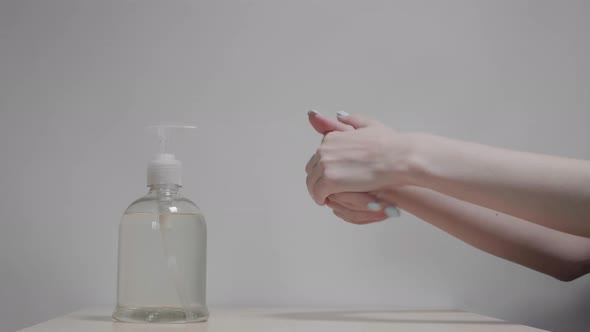 Women's Hands Apply Sanitizer Gel