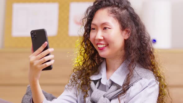 Asian girl contacts with friends through video call. Mobile distance virtual meeting. Stories of all alt