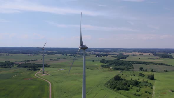 Aerial view of windmills farm for energy production on beautiful cloudy sky at highland. Wind power  alt
