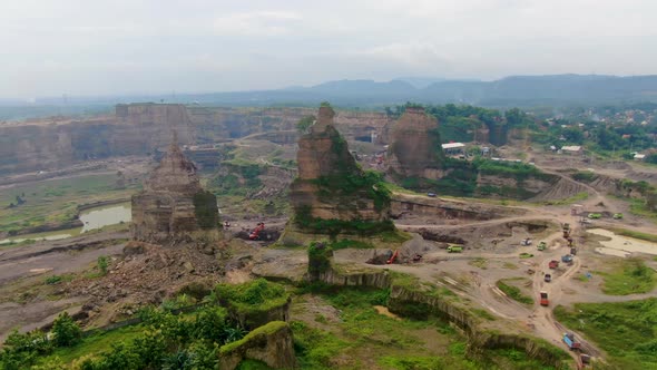 Aerial truck drive though opencast sand mine Brown Canyon in Semarang Indonesia alt