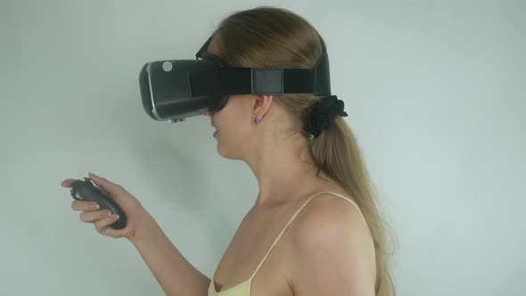 Young Girl Uses A Virtual Reality Helmet In A Simulation Game alt