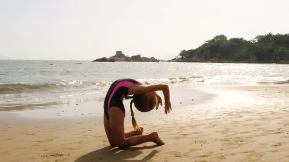 Little gymnast at the sea