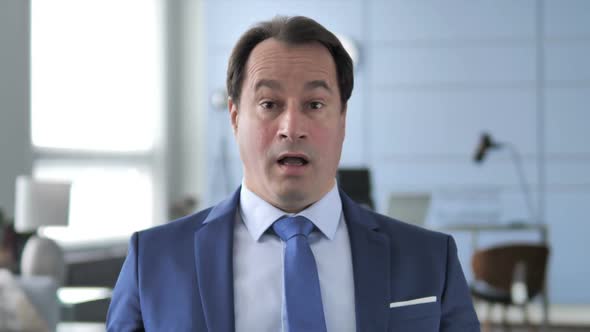 Portrait of Businessman in Shock Wondering in Awe alt