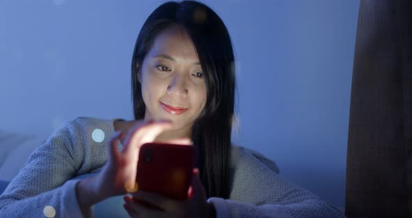 Woman use of mobile phone at home alt