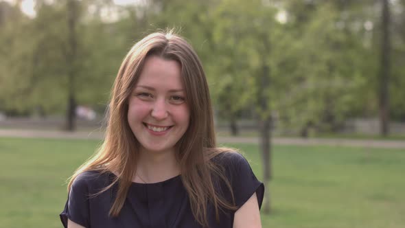Smiling Girl on Background of Summer Park alt