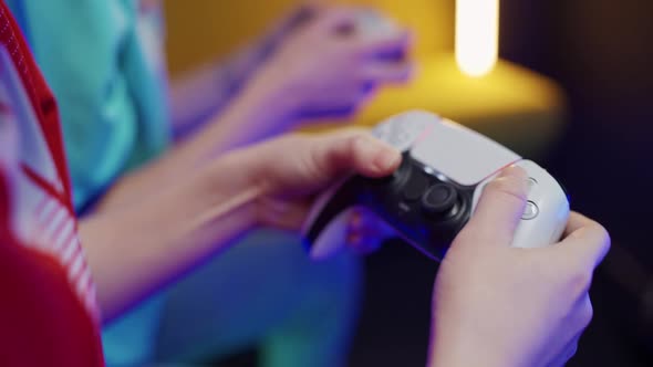 The Confrontation of Two Players Gamers Plays a Video Game on a Game Console Closeup View of Hands alt