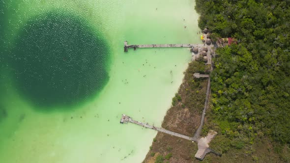 Aerial Birds Eye Overhead Top Down Descending View of People Swimming and Relaxing in Emerald Green alt