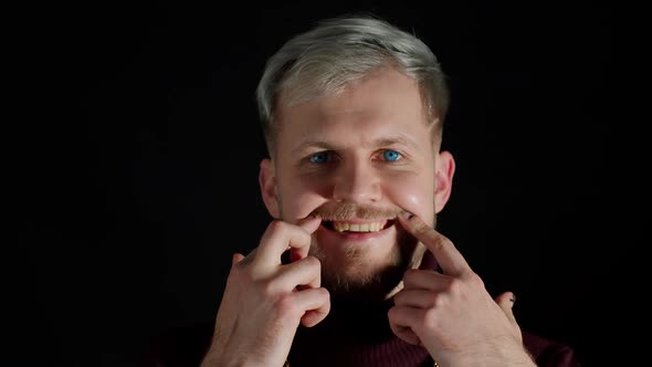 Stylish Young Man Looking at Camera Feeling Happiness Fun and Enjoyment Showing Smile Gesture alt