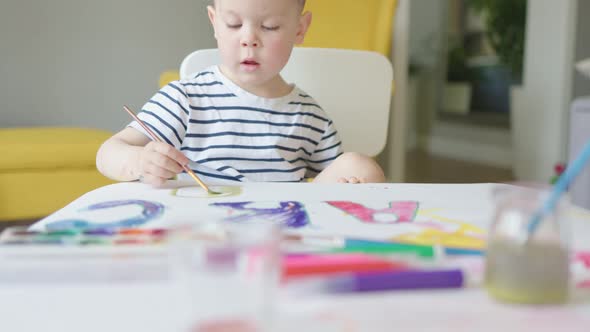 Preparing First Day at School Concept Child Kid Boy Drawing ABC Letters on Paper alt