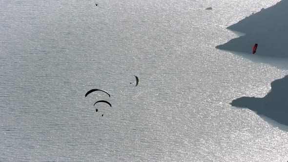 Paragliders Flying With Paragliding in Sky Over the Forest, Mountain Top and Sea alt