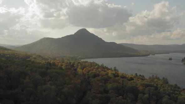 Late evening light on the early fall foliage with a train track leading towards a distant mountain A alt