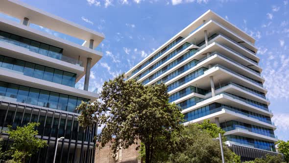 Clouds Moving Over Modern Office Buildings alt