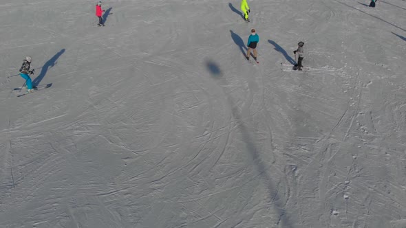 Skiers and Snowboarders on Snow Slope of Resort in Mountains at Winter Day Aerial View Sport and alt