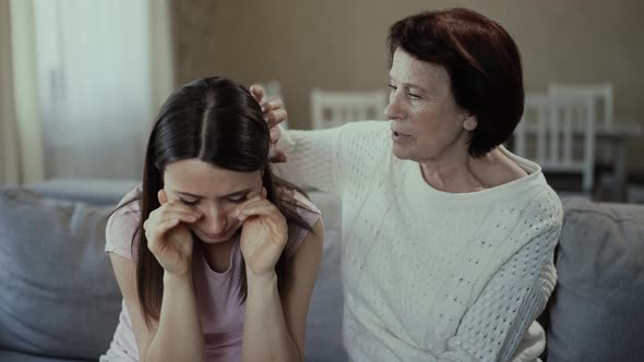 Mother Calms Her Crying Daughter alt