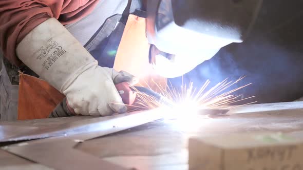 Welder Worker Hand Welds Metal Constructions. Workman In Workshop. Welding Process