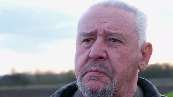 Senior Man Turning Head at Camera alt