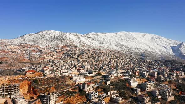 Hermon mountain ridge covered with snow during 2022 winter, with the town houses of Majd al Shams. alt