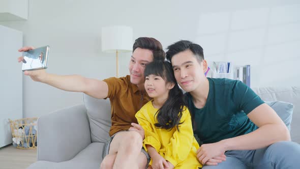 Asian attractive LGBTQ gay family spend time with girl kid daughter. alt