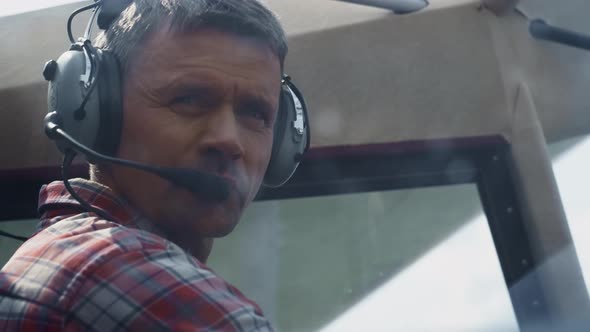 Closeup Airplane Pilot Face Wearing Headset with Microphone Sitting Plane Cabin alt