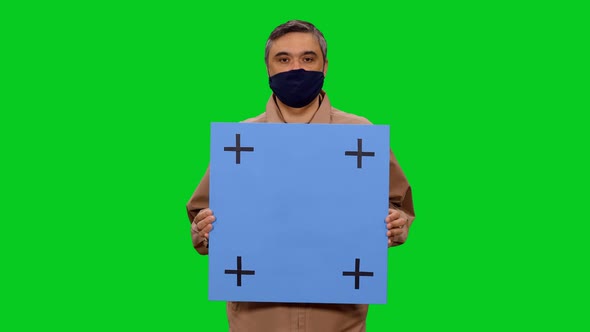 Man in Protective Mask Speaking While Standing with Blue Blank Billboard, Chroma Key
