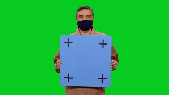 Man in Protective Mask Speaking While Standing with Blue Blank Billboard, Chroma Key alt