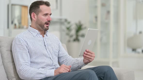 Failure, Young Man with Loss on Tablet at Home  alt