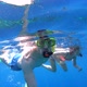 Couple diving and snorkeling together in tropical ocean water - VideoHive Item for Sale