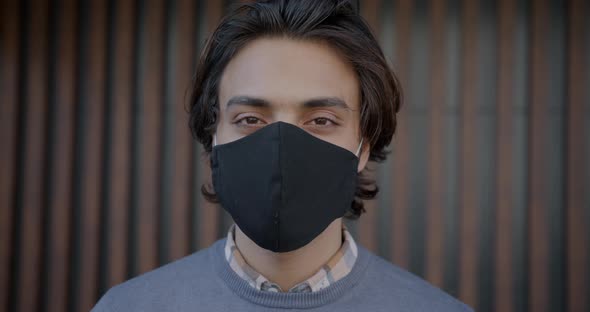 Closeup Portrait of Middle Eastern Man Wearing Multipleuse Face Mask Outdoors alt