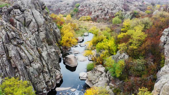 A Picturesque Stream Flows in the Aktovsky Canyon, Surrounded By Autumn Trees and Large Stone alt