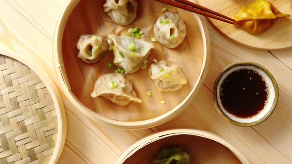 Traditional Chinese Dumplings Served in the Wooden Bamboo Steamer alt