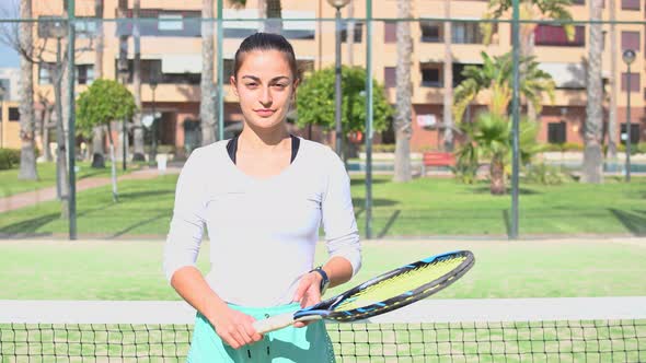 Beautiful Tennis Player Looking at the Camera Smiling and Walks