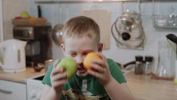 Caucasian Boy Makes Funny Faces in Kitchen alt