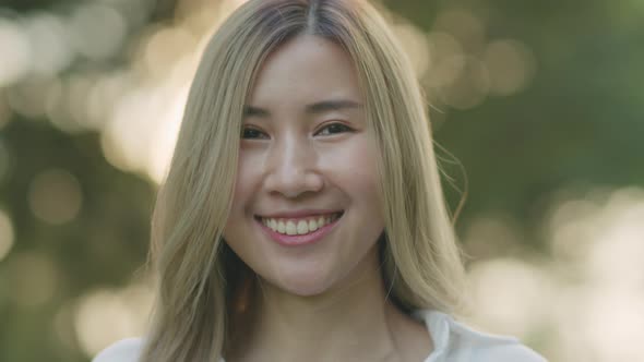 Smiling of portrait Asian female looking up at the camera.