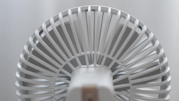Back View of Modern White Portable Electric Fan on Light White Background