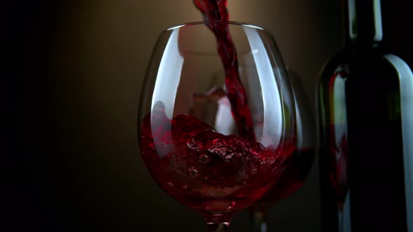 Super Slow Motion Shot of Pouring Red Wine From Bottle with Camera Rotation at 1000Fps alt