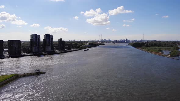 Reflection Of Sunlight In The River In Kinderdijk Town With Skyline On The Background. aerial alt