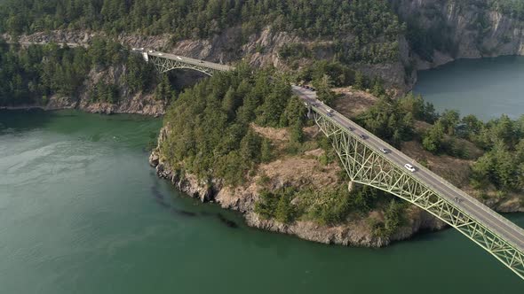 Beautiful Aerial Of Cars On Road Trip Crossing Large Bridge Between Pacific Northwest Ocean Islands alt