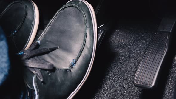 Accelerator and break pedal in a car. Close up the foot pressing foot pedal of a car to drive. alt