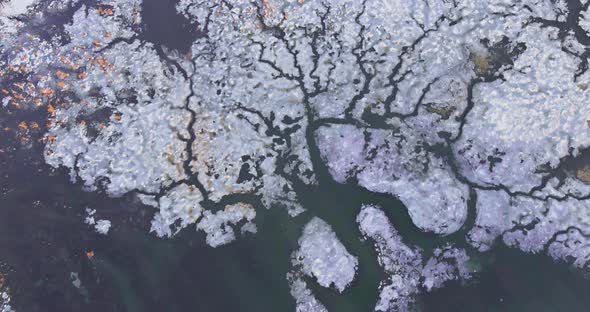 Ice Drift on Pieces of Melting Ice Under the Bright Spring Sun on the River Bank alt