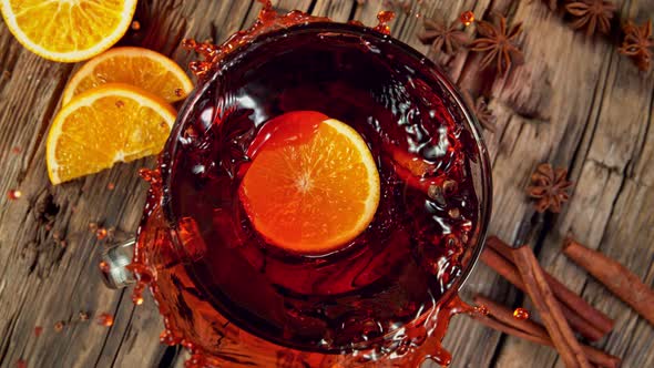 Super Slow Motion Shot of Orange Slice Falling and Splashing Into Mulled Wine at 1000 Fps alt