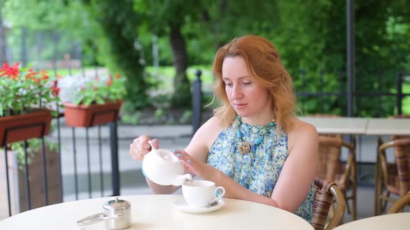 Happy Smiling Woman Making Green Tea Outdoors. Summer Background. Healthy Eating Concept. Shallow