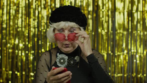 Shocked Senior Old Woman Typing Message on Social Network, Using App, Online Shopping. Slow Motion alt