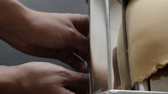 Dough processed  with pasta machine 4K 2160p 30fps UltraHD footage - Lasagna sheets making in the ki alt