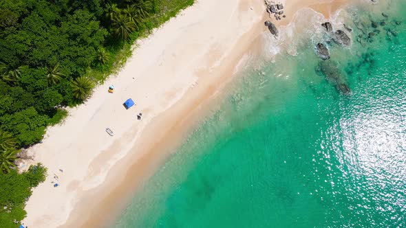 Aerial view shot. Drone camera over white beach sand and sew water clear. Nature video view of beaut alt