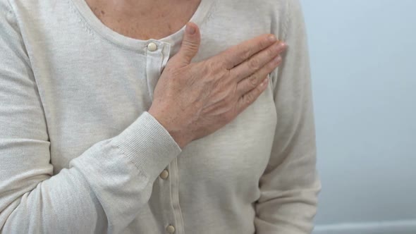 Elderly Woman Holding Hand on Chest, Health Examination, Doctor Appointment