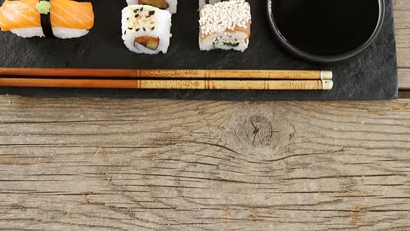 Set of assorted sushi served on black stone slate alt